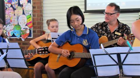Students playing classical guitar