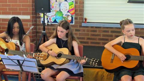 Students playing classical guitar